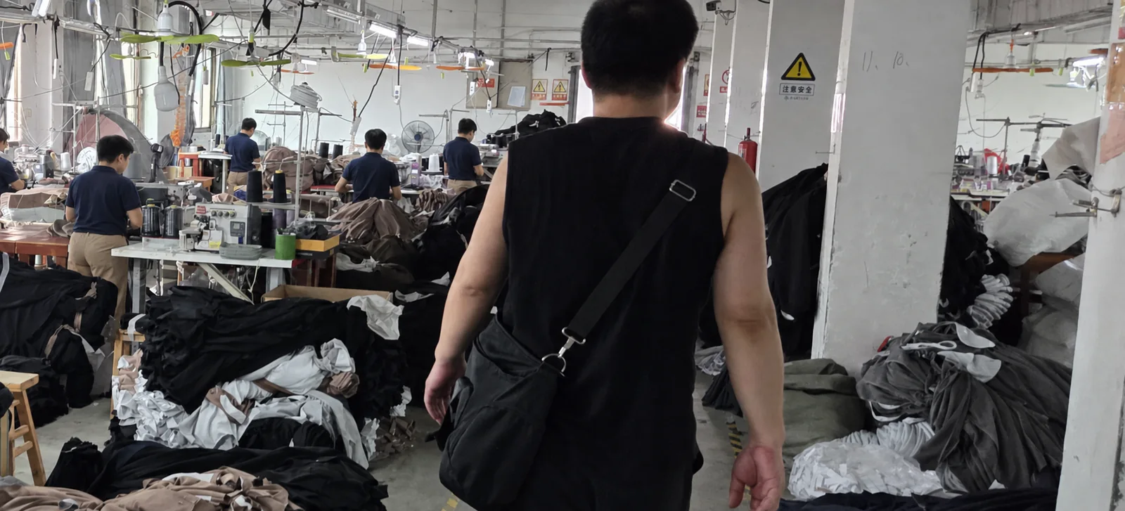 Walking the aisle of a sewing floor mid-run, with stations working on both sides