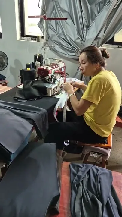 Worker at the sewing machine, mid-production — IPQC