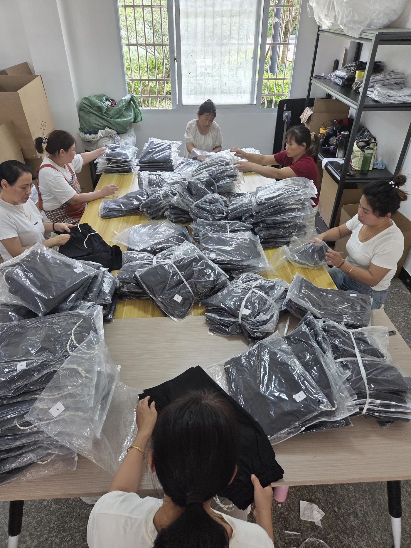 Workers checking and processing finished units on the production floor