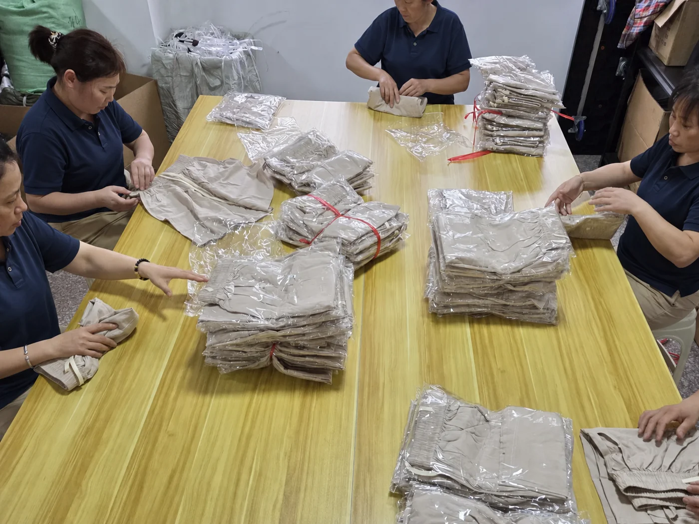 Our team bagging and boxing finished garments before dispatch