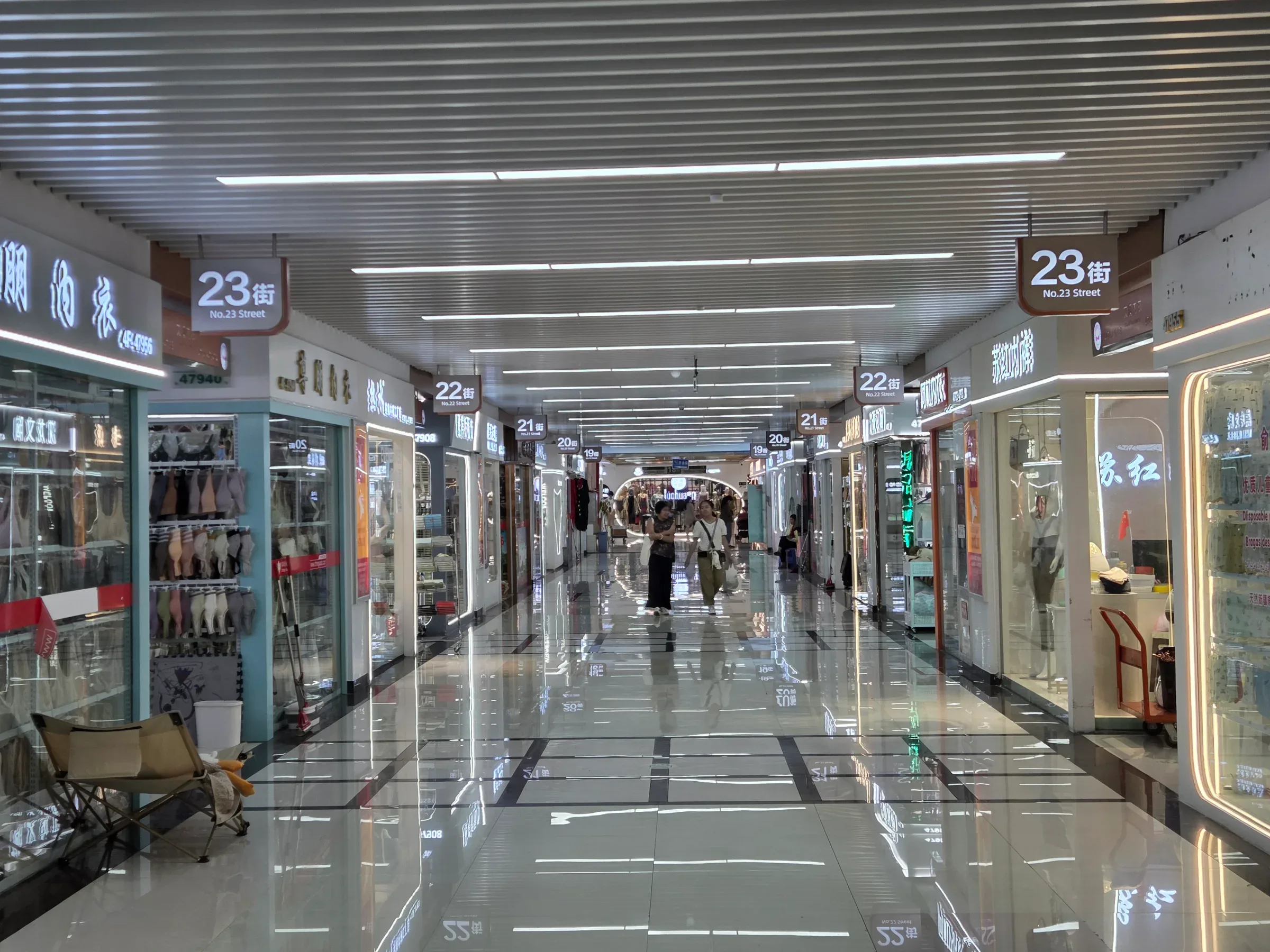 An empty aisle of supplier booths in Yiwu Market on a weekday afternoon